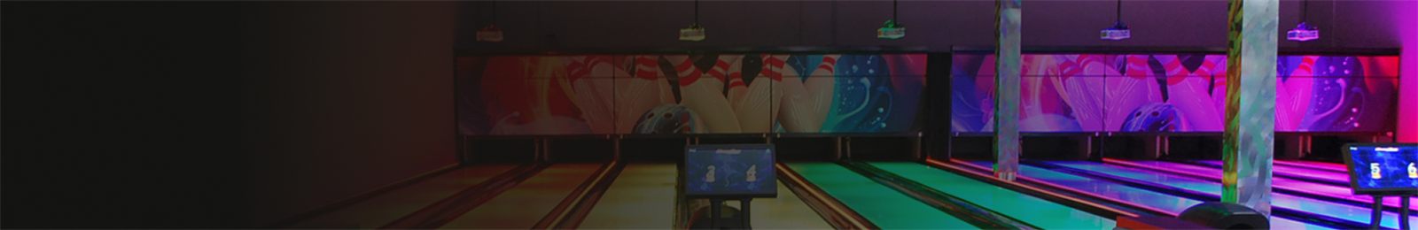 Full-size bowling lanes at GameTime Daytona, lit for play