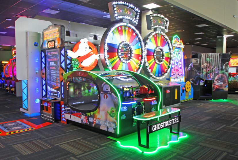 A large lit attraction and racing games on the floor at GameTime Fort Myers