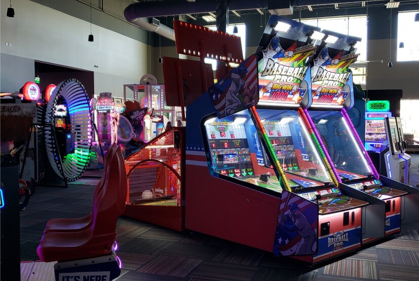 Racing and basketball cabinets on the game floor at GameTime Kissimmee
