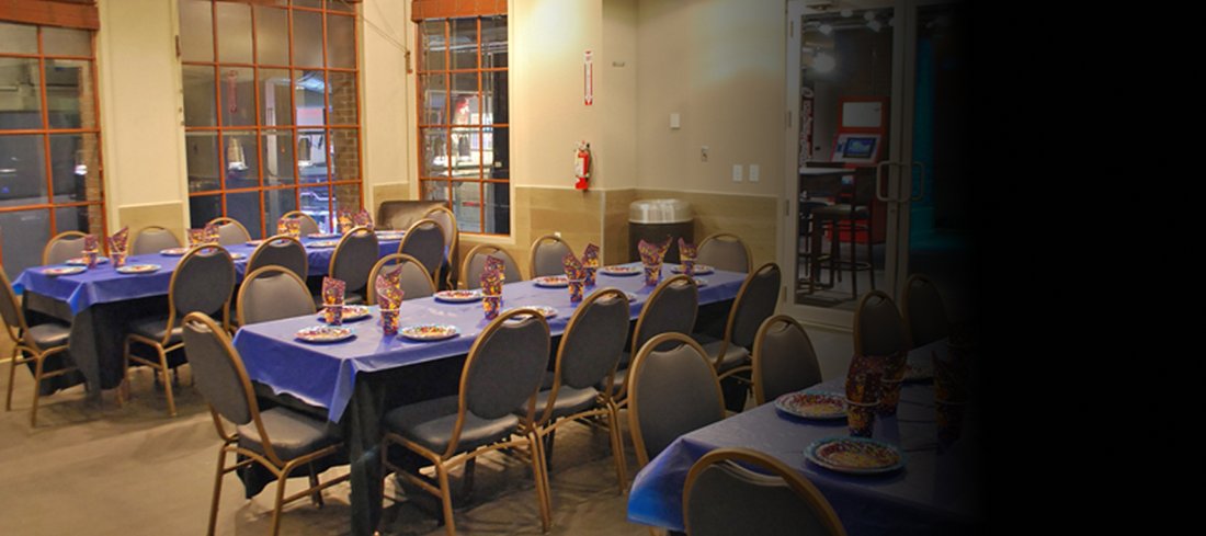 Tables set for a group beside the windows at GameTime Miami