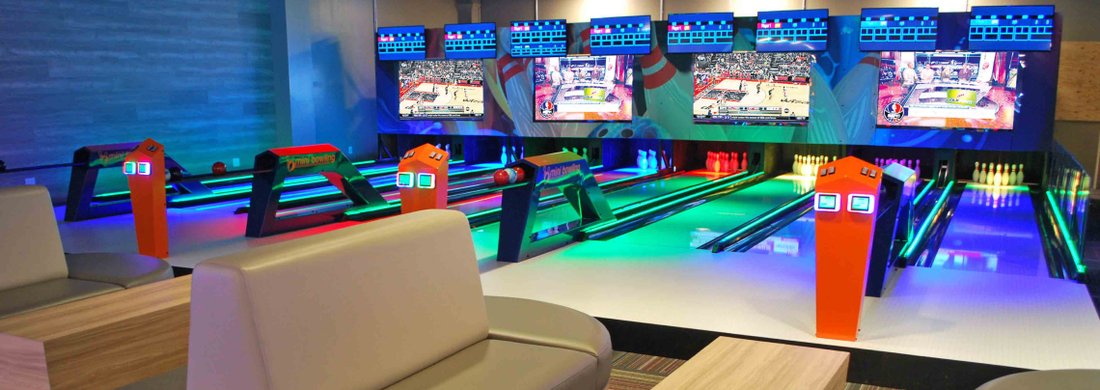 Mini bowling lanes lit blue and green at GameTime Ocoee
