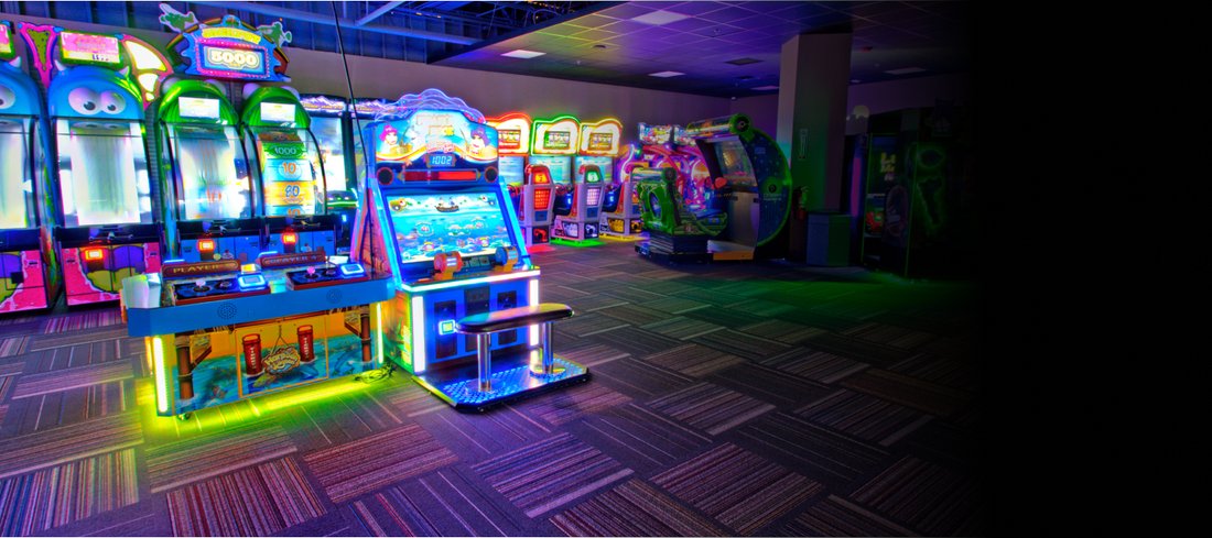 Lit arcade cabinets along the game floor at GameTime Ocoee
